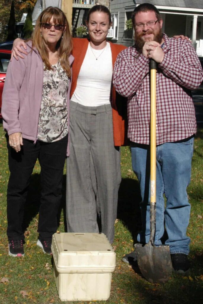 Retiring Clerk Melanie Laraway, Deputy Clerk Rebecca Kelley, and Mayor Timothy Knight pose the capsule